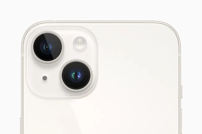 Close-up of a white iPhone back in the top-left corner, showing the dual-camera module and flash.