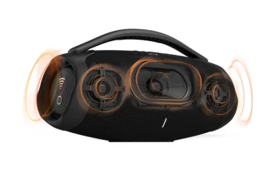 Black VR headset with built-in speakers and exposed drivers highlighted in orange.
