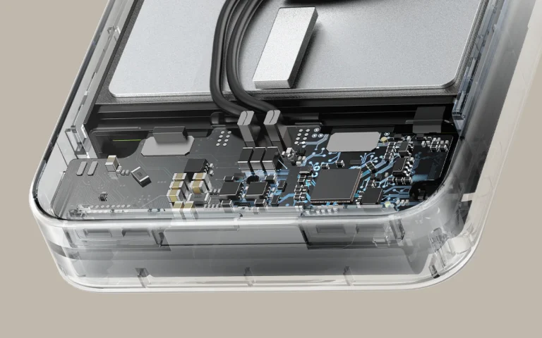 Close-up of an electronic circuit board inside a transparent casing, showing chips, capacitors and blue traces.