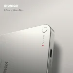 Close-up of a silver Momax 8.3mm Ultra Slim portable charger, displaying LED indicator lights and a USB-C port on the side.