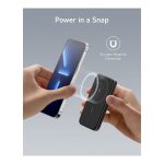Two hands demonstrate snap-on magnetic wireless charging between a phone and a small charger.