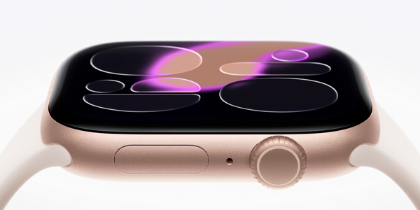 Close-up of a rose-gold Apple Watch with a white band, showing the digital crown and side button.