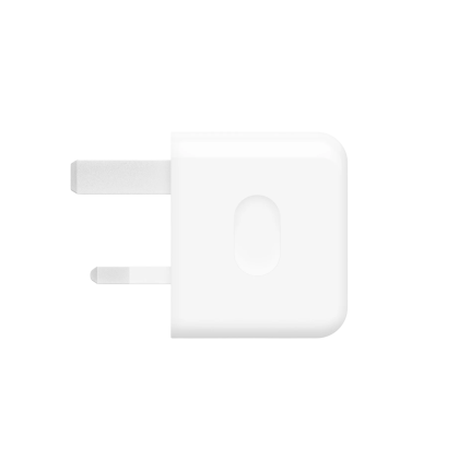 Close-up of a white wall power adapter with two flat prongs visible on the left and a rounded right edge.