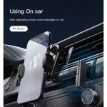 Phone mounted on a car air vent wireless charging cradle with blue charging rings on the dashboard